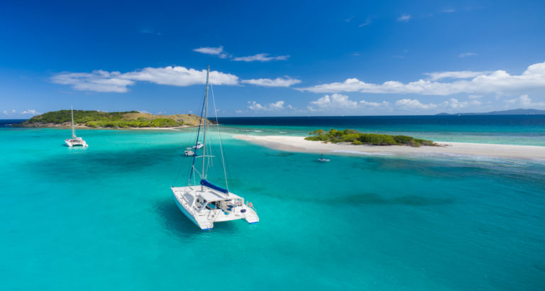 Catamaran at anchor in front of deserted island