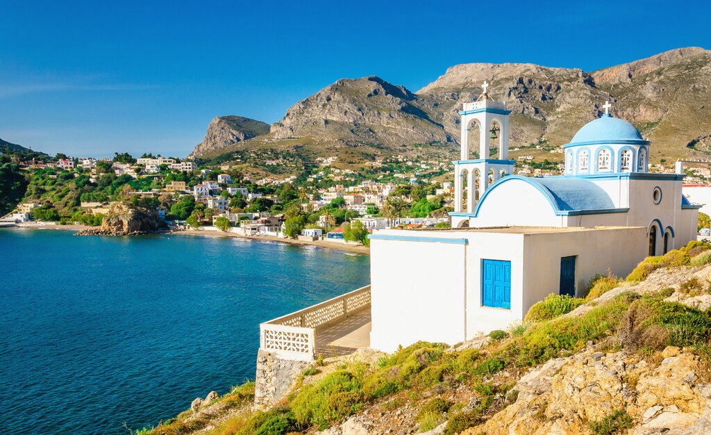 Iconic white church with blue domes, Greece